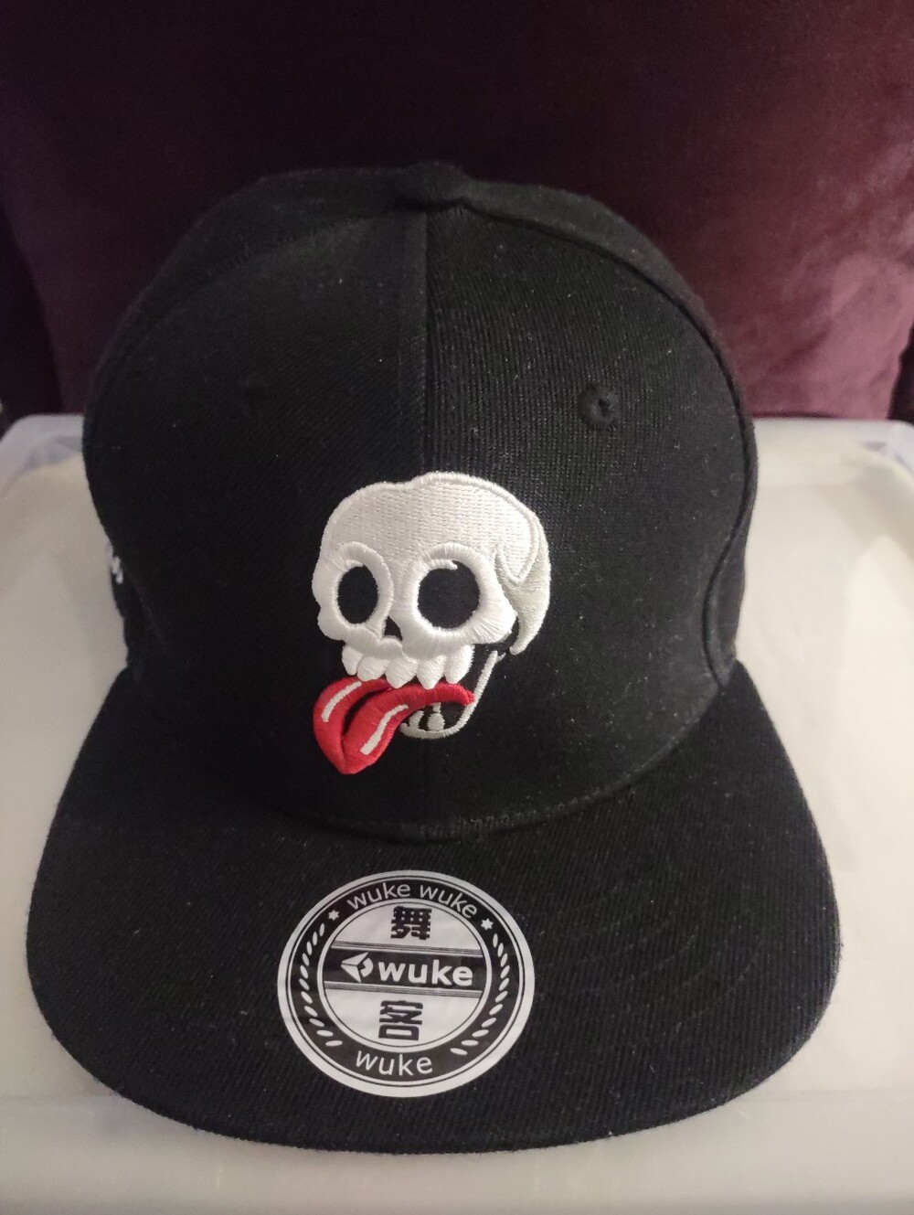 WUKE_Embroidered Skull Gesturing Snapback Cap